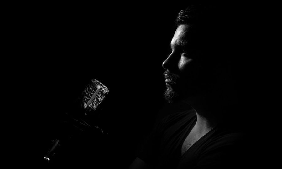 Episode 44: Buy, Sell, Something or Nothing & Odds Makers Shows Man at Microphone.